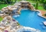 Natural pool with boulder falls and in pool table and stools.