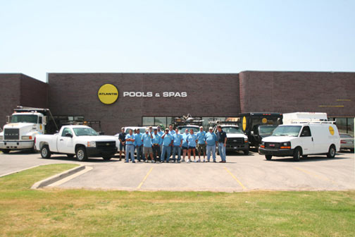 The Atlantis team standing in front of the Atlantis Pool offices.