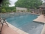 Raised wall with sheer decent waterfalls pouring into pool.