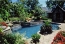 Spa and water feature spilling into swimming pool.