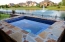 All glass tiled spa overlooking a pond.