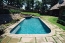 Long pool with a tanning ledge and raised spa.