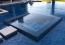 A picture of an all tiled perimeter overflow spa with a vanishing edge pool.