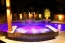 Double side spillover spa with a pool.