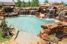 Large boulder waterfalls with all tiled slide through waterfall