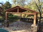 A covered structure with stone patio.