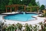 Geometric shaped pool with brick coping and raised spa.