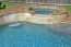 Spa and water feature spilling into swimming pool.