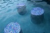 Stools in a pool with glass tiled seating