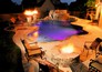 Free form pool with fire features and fire pit with raised spa.