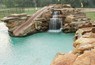 Grotto waterfall with an all tiled giant slide.