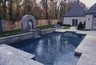 Water feature spilling into swimming pool.
