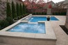 Rectangle pool with square spa spilling into pool.