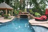 Multi level decking around a pool with a grotto.