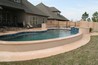 Bi-level decking around a pool with a raised spa.