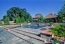 Pool with cut stone decking and a waterfall into pool.