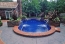 All tiled swimming pool with water features.