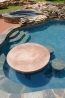 In-pool table and stools with a spa in the background.