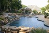 Free form pool with spa and boulder waterfalls.