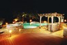 An infinity edge pool with a raised spa and water falls.