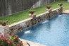 Close up view of waterfalls coming out of a stone wall.