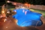 Free form pool with a boulder waterfall and custom rail at stairs.