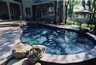 Small pool with a stone wall and water spouts.