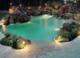 A huge pool with multiple waterfalls, grottoes and a spa.