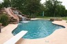Large slide into swimming pool with a boulder waterfall.