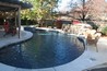 Free form pool with boulder waterfalls and a spa.